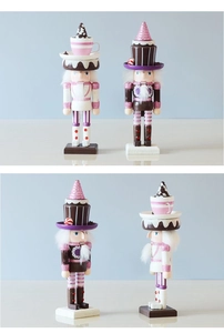 Multiple views of pink and purple dessert-themed wooden Nutcracker dolls with cakes