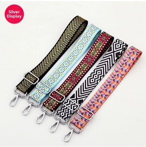 Detailed view of adjustable patterned shoulder straps with silver metal hardware buckles