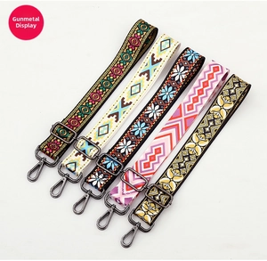 Detailed view of adjustable ethnic style bag straps with gunmetal swivel hooks