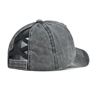 Detail view of the black elastic criss-cross back on the washed grey ponytail baseball cap