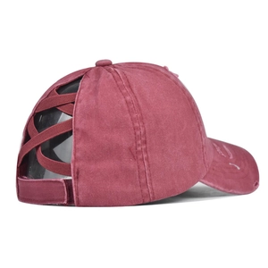 Detail of cross elastic ponytail band design on a washed vintage baseball cap