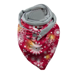 Detailed view of red Christmas scarf with white snowflake pattern and button closure