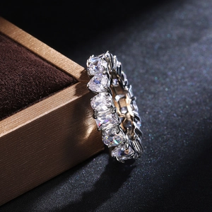 Macro shot of silver eternity ring with heart-cut stones in a premium velvet box