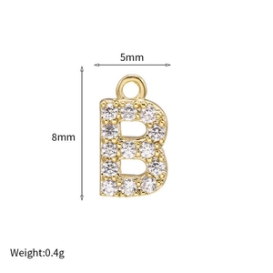 Macro detail of gold letter B pendant with micro-set zircons showing 8mm by 5mm size