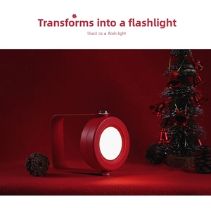 Detail of red portable LED lantern lamp showing flashlight mode in a Christmas setting