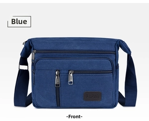 Front view of a navy blue canvas crossbody bag with multiple zipper compartments and strap