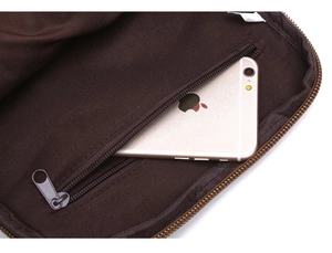 Detailed view of canvas shoulder bag inner lining with a zipped pocket and phone for scale