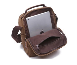 Internal view of brown canvas shoulder bag showing spacious main pocket with a tablet