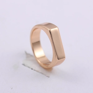Detailed close-up of a vintage golden rectangle ring with a polished minimalist surface