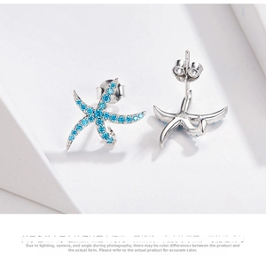 Macro shot of S925 sterling silver starfish earrings with blue cubic zirconia stones