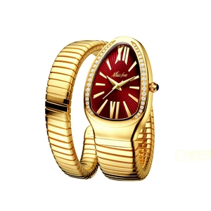 Detail of gold snake-shaped wrap watch with red sunray dial and crystal bezel