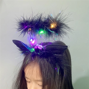 Detail of black feather headband with colorful LED lights for kids festive costumes