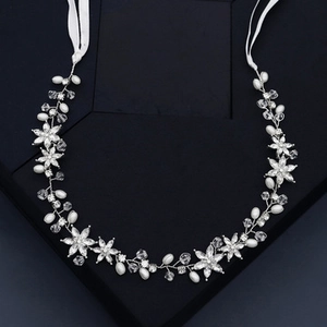 Detail of bridal headband with imitation pearls and rhinestones on silver wire