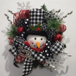 Detailed Christmas wreath featuring a snowman doll with plaid bows and pine branches
