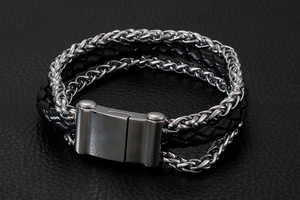 Detail of multi-layer men's bracelet with braided leather and steel curb chain