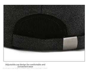 Detail of adjustable metal buckle on textured dark grey wool baseball cap for men