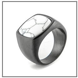 Detail of vintage matte black men's ring featuring a textured white stone inlay