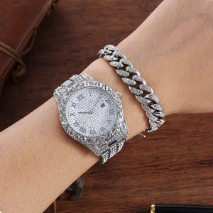 Close-up of luxury iced-out watch set with Cuban link bracelet in silver steel