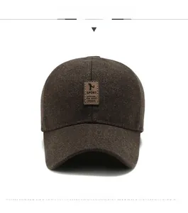 Close-up of brown winter baseball cap with leather sport patch and warm thick fabric