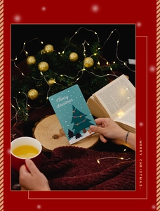 Close-up of a festive 3D Christmas card featuring a green tree and Merry Christmas text