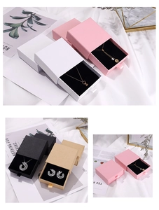 Detail of drawer-style jewelry gift boxes with satin pull tabs and soft velvet inserts