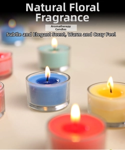 Macro shot of colorful scented tealight candles burning in clear glass containers