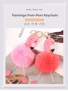 Detail of pink and red fluffy flamingo fur ball keychains with golden metal clasp