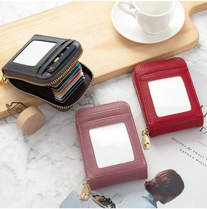 Detail view of multi-color leather card holders with gold zippers and clear ID windows