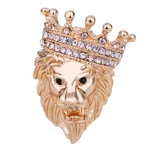 Macro detail of a golden lion head brooch with sparkling rhinestone crown decoration