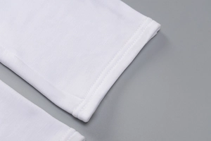 Detailed close-up showing the high-quality double-needle stitching on white knit fabric
