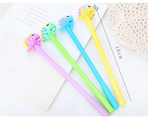 Close-up of four colorful dinosaur pens with soft silicone charms, 18cm length detail