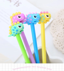 Close-up of cute cartoon dinosaur neutral pens in four colors on a study desk