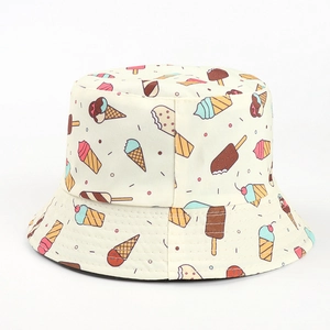 Close-up of beige bucket hat featuring colorful cartoon ice cream prints on cotton canvas