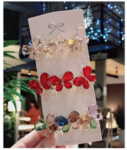 Detailed view of three butterfly crystal hair clips featuring elegant rhinestone designs