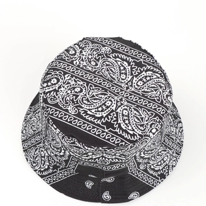 Top view of a reversible bucket hat with black and white paisley print on cotton fabric