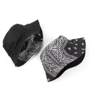 Detail of a double-sided bucket hat with classic black exterior and paisley pattern interior