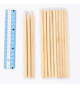 Flat lay of thirteen hexagonal HB pencils in natural wood showing sharpened and unsharpened tips