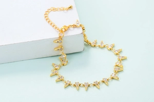 Close-up of golden geometric link bracelet with zircons on a minimalist pedestal