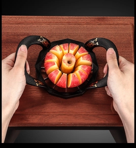 Hands using a zinc alloy apple slicer with gold patterns on a wooden board
