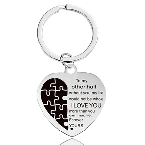Macro detail of heart-shaped keychain with puzzle piece and romantic engraving
