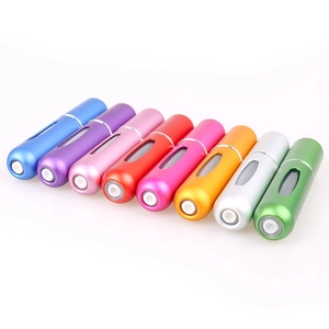 Detailed view of 8 colorful aluminum travel perfume atomizers with viewing windows