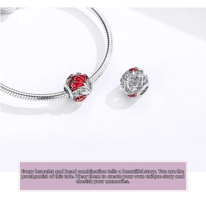 Close-up of S925 sterling silver snake chain bracelet with red enamel floral charms