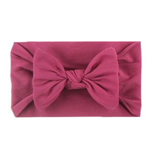 Soft rose red nylon bow headband for babies with elastic knitted fabric texture