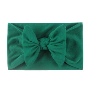 Soft nylon baby headband with a large dark green bow for toddlers and infants