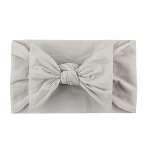 Soft nylon baby headband with a large bow in light grey, comfortable infant hair accessory
