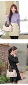 Close-up of contrast color handbag in beige and dark brown leather with brand logo