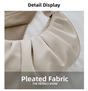Close-up of the elegant cream-white cloud bag with detailed pleats and leather texture