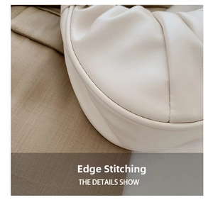 Macro detail of the cloud bag showing premium ruched leather texture and fine edge stitching