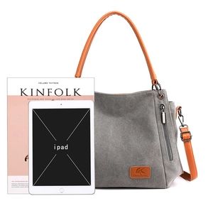 Grey canvas messenger bag with brown straps shown next to an iPad for size reference