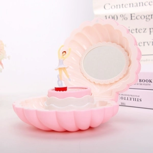 Pink shell music box featuring a rotating ballerina figurine and round vanity mirror detail